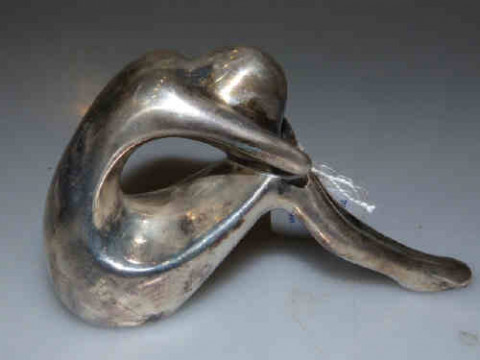 Silver model of a seated girl, stamped SILVER/990, filled