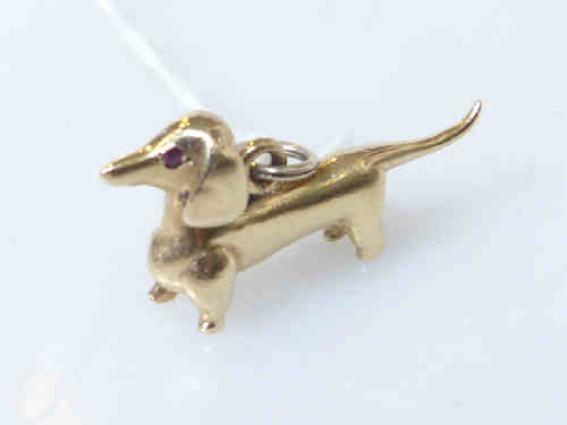 9ct gold dog-form charm, hallmarked, with red stones inset as eyes, approximately 10grams