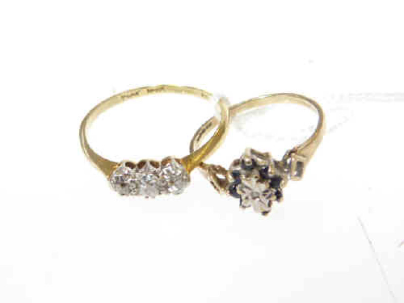 Three stone diamond ring, stamped 'PLAT' and '15', size Q; and a 9ct gold sapphire and diamond ring, size K