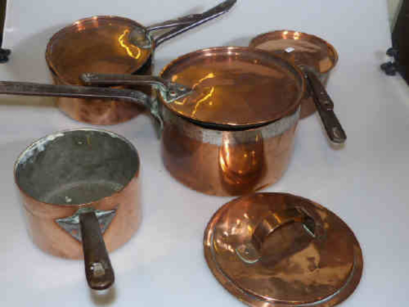 Collection of four 19th Century copper pans and lids
