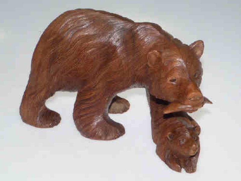 Carved wood bear feeding cub