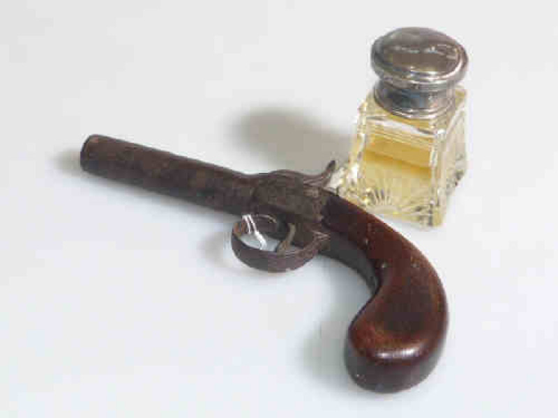 Antique boxlock pocket pistol and silver topped bottle (2)
