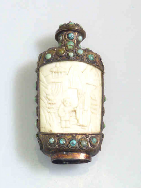 Ornate metal scent bottle set with blue stone and two carved ivory panels