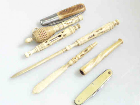 Bag of ivory pieces, cigarette holder, tape measure, etc