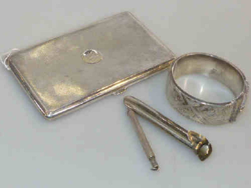 Silver engine turned cigarette case and bangle, and a pencil and posy holder (4)