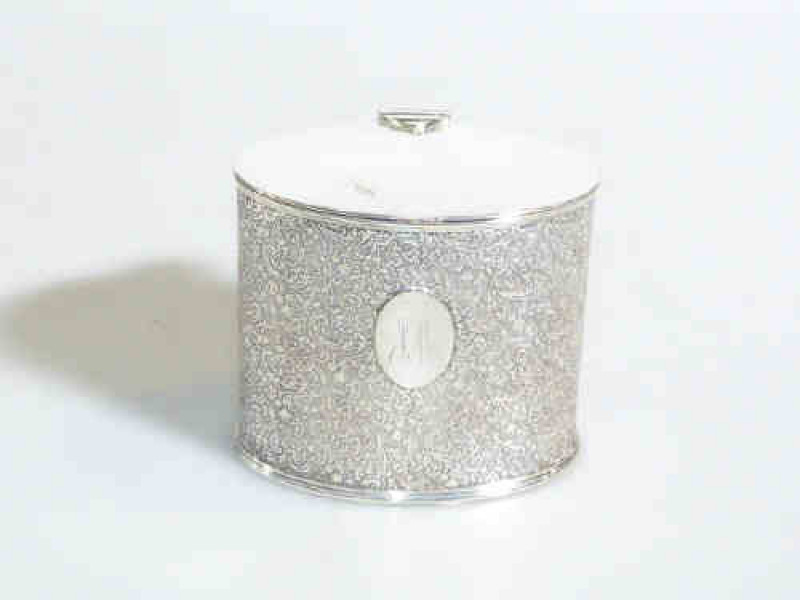 Silver plated oval caddy with overall scroll decoration