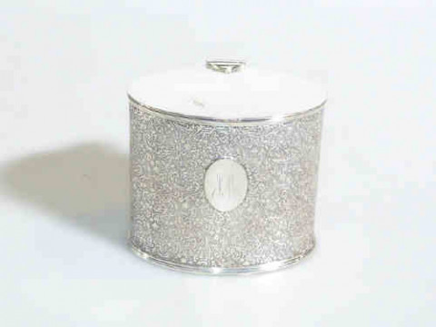 Silver plated oval caddy with overall scroll decoration