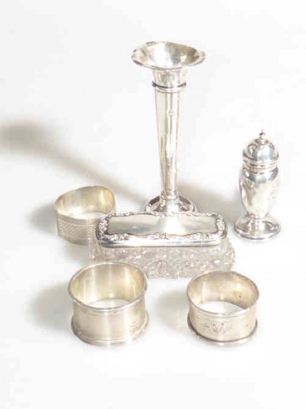 Three silver napkin rings, silver vase, pepperette and topped jar (6)