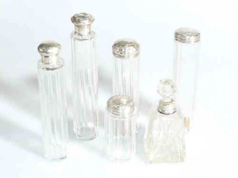 Five silver topped toilet bottles and silver mounted scent bottle (6)