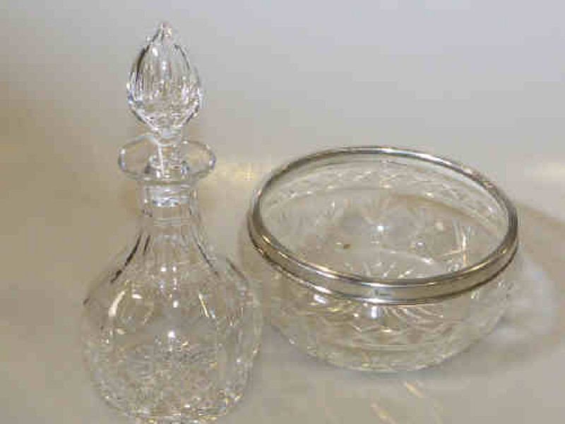 Cut glass decanter and stopper and a glass bowl with silver rim