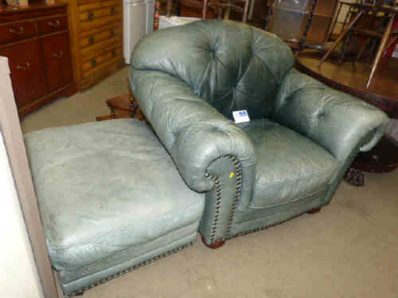 Green buttoned leather and studded easy chair and footstool