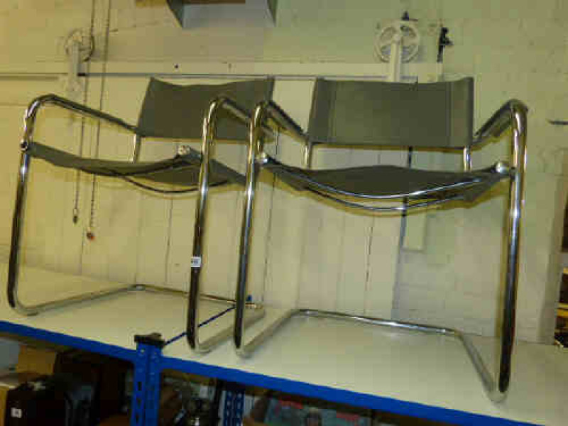 Pair grey leather and tubular elbow chairs