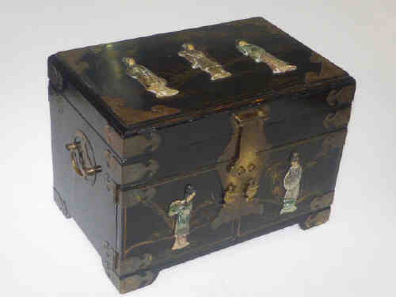 Oriental black lacquered jewellery cabinet with applied relief figure and brass fittings