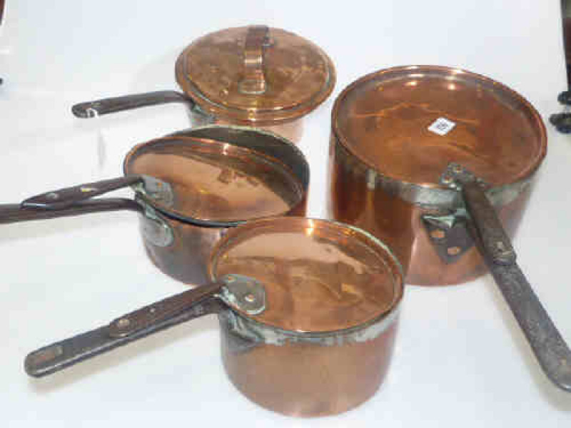 Four highly polished Victorian copper pans with steel handles