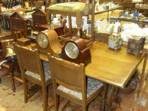 Old Charm oak refectory dining table and five linen fold panel back chairs