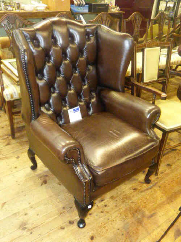 Gents buttoned back brown leather wing fireside chair