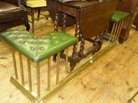 Brass club fender with buttoned green leather corner seats