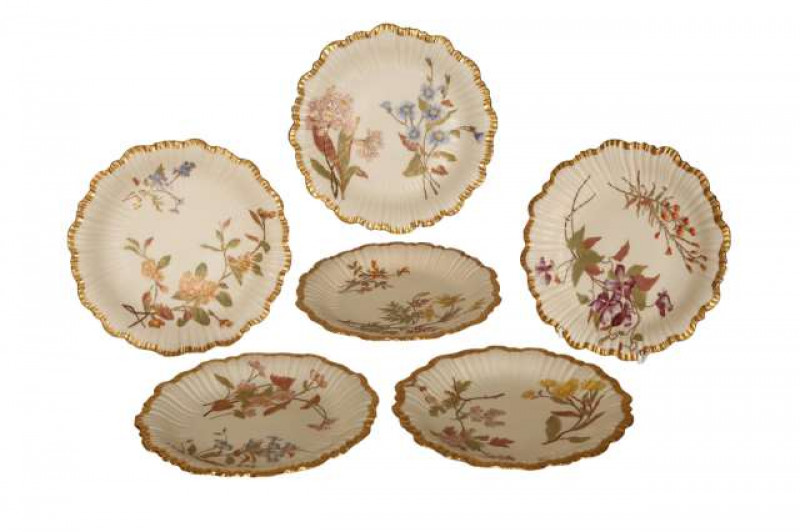 A set of six Royal Worcester shell plates, each decorated with flowers on a blush ivory ground, embellished with gilding, c.1915/16, shape no. 1416, puce printed factory marks. 21.5cm