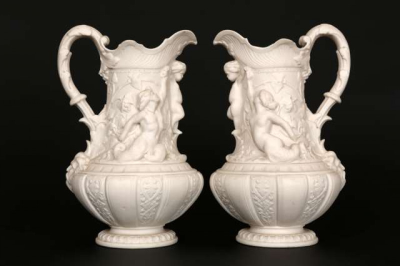Minton, a handsome pair of Renaissance Revival parian jugs, each boldly moulded with a mermaid and merman supporting cupid, date mark for 1858. 27cm