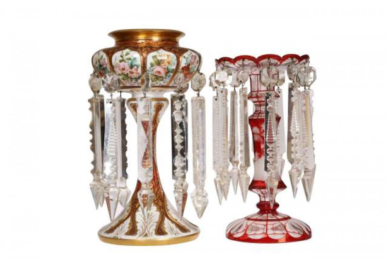 A Bohemian 19th Century overlaid glass table lustre, the white overlay painted with flowers, the ruby glass gilded with scrolling foliage; together with a Bohemian 19th Century ruby and clear glass table lustre, the waisted and faceted stem etched with a 