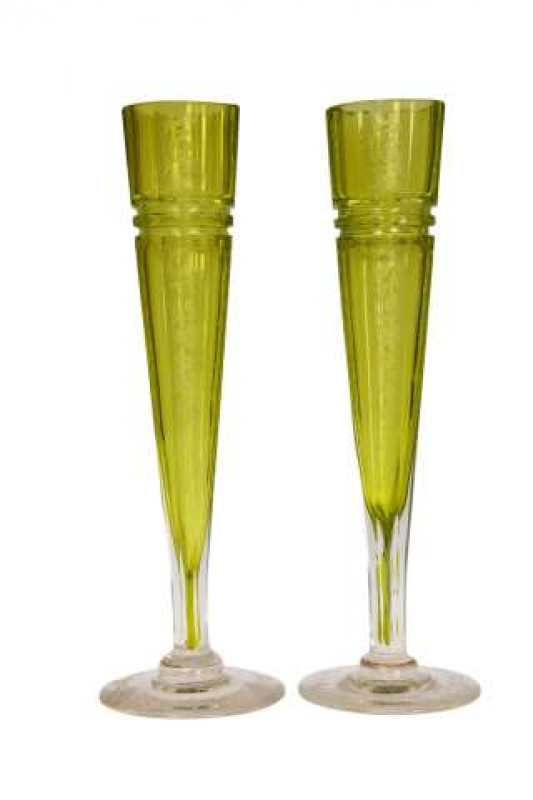 A pair of Continental 19th Century green glass vases, probably French, the tapering faceted flutes engraved with formal scrolls and trellis, raised on engraved circular feet. 28cm