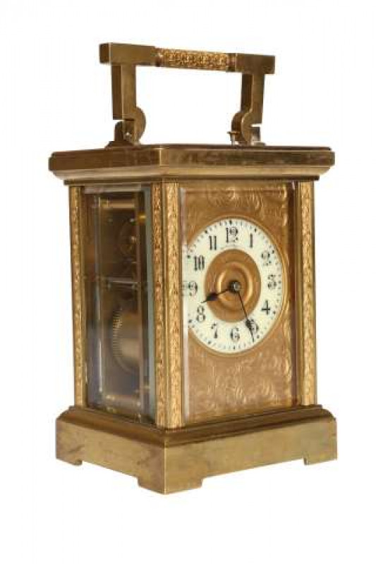 A French 19th Century brass cased repeater carriage clock, the white enamel dial, signed Hamilton ***/ Calcutta and France, within a foliate and scroll engraved plate, striking and repeating on a coil going. 18.5cm high to top of handle