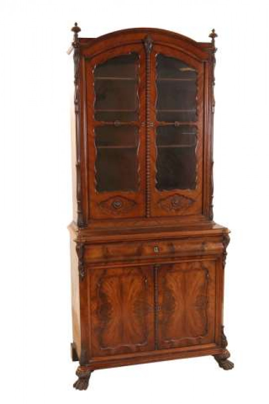 A 19th Century mahogany secretaire bookcase, the upper section with arch top and conforming glazed doors, enclosing a divided interior, the base with secretaire drawer above a pair of panelled doors, raised on claw feet. 228cm by 107cm by 50cm