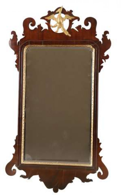 A George III mahogany fretwork mirror, the crest carved with a phoenix, the gilt slip enclosing a bevelled plate. 88cm by 49cm