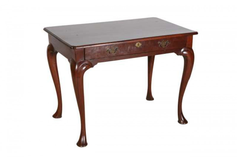 A mahogany side table, George III and later, the moulded top above a frieze drawer, fitted with brass backplate handles and escutcheons, raised on cabriole legs terminating in pads. 64.5cm by 86.5cm by 53cm