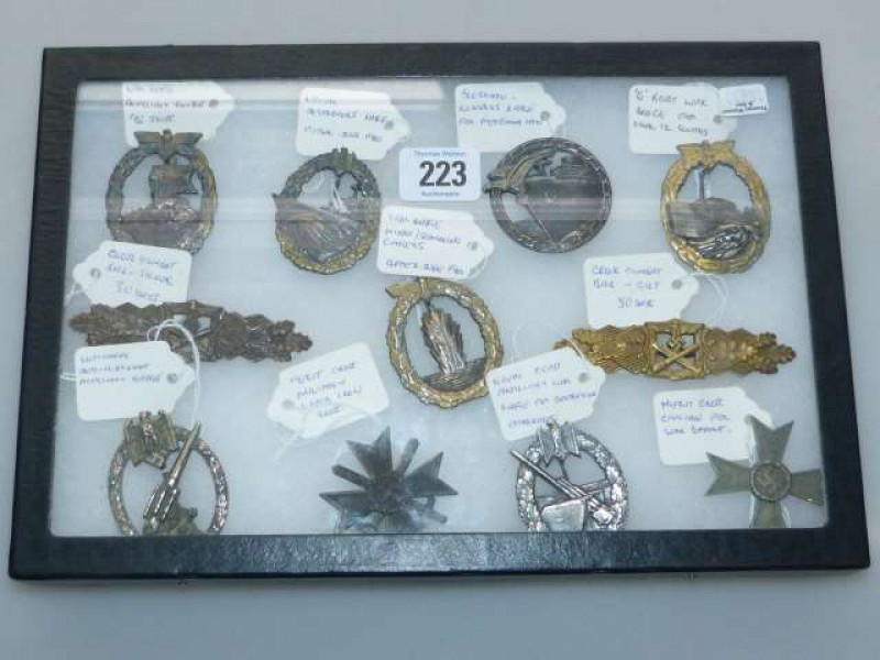 Collection of eleven German badges including Two Close Compact Bars, Blockade Runners, Naval Destroyers, Merit Cross, Naval Coast Artillery, etc