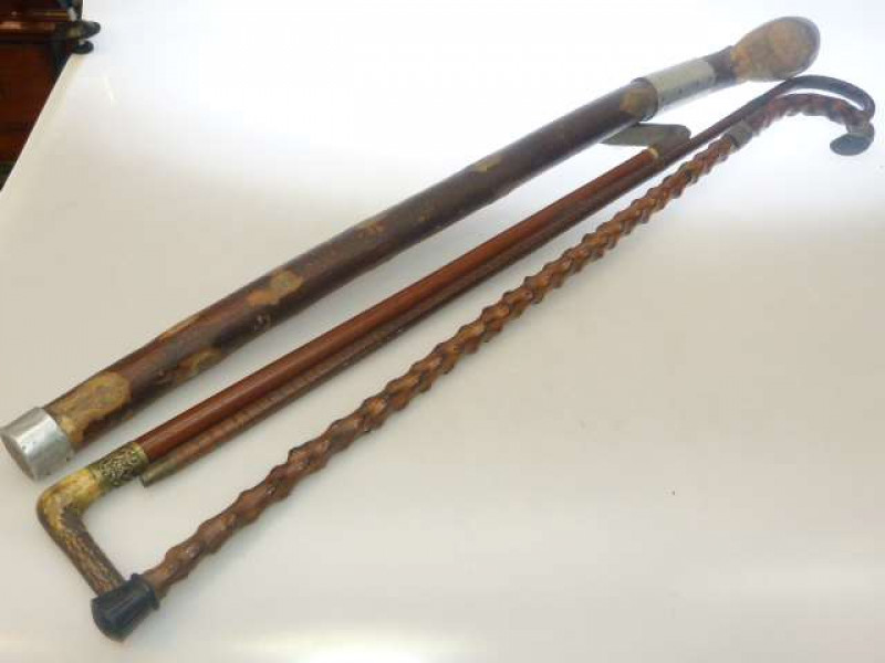 Silver mounted walking stick and two others and horn handled riding crop