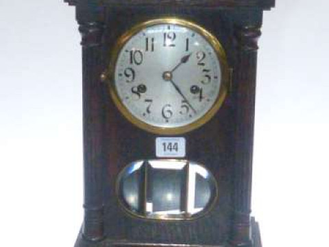 Oak arch top mantel clock with silvered dial