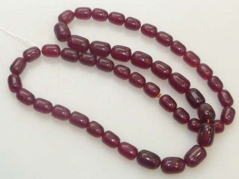 A cherry amber bead necklace, total length 74cm