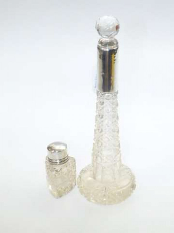 Two cut glass bottles with silver collar and silver top