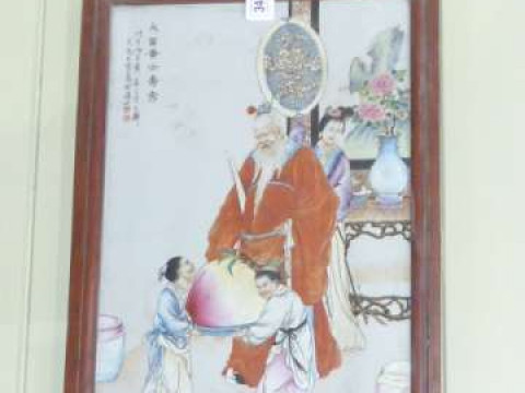 Framed Oriental famille rose panel depicting a Chinese elder being waited...
