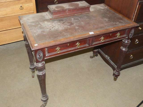Late 19th Century mahogany two drawer writing table on turned reeded legs