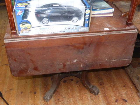 Regency mahogany Pembroke table on turned pedestal to four splayed paw...
