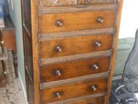 Carved oak chest of two short above five long drawers