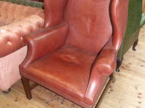 Georgian style brown leather wing easy chair on square moulded legs