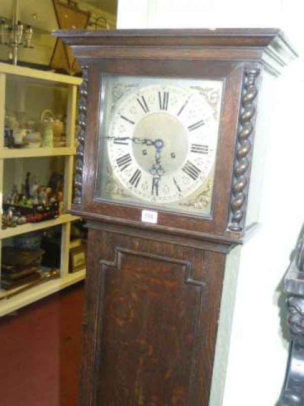 1920's oak Jacobean style grandmother clock having square brass and silvered dial