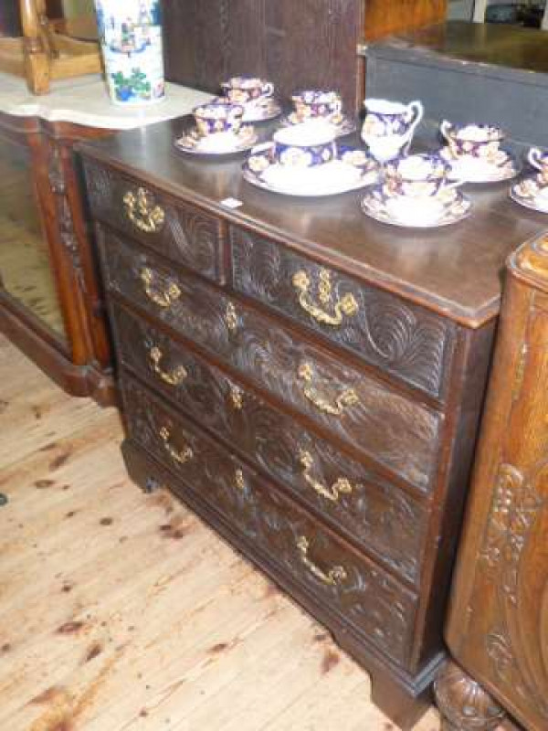 19th Century carved oak chest of two short above three long drawers on bracket feet