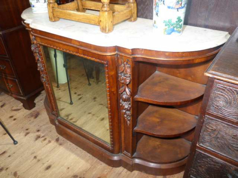 Victorian walnut and marble topped shaped front credenza having central mirror door flanked by open ends