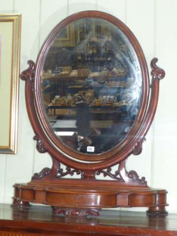Victorian mahogany oval toilet mirror on shaped front base