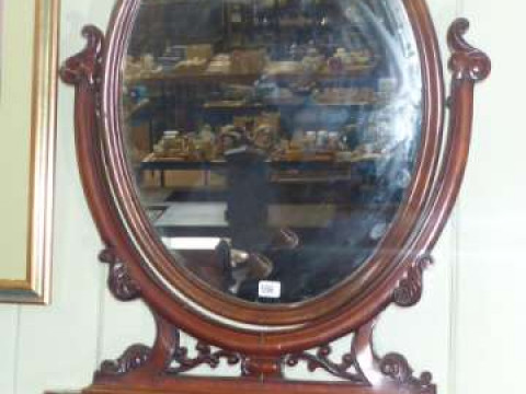 Victorian mahogany oval toilet mirror on shaped front base