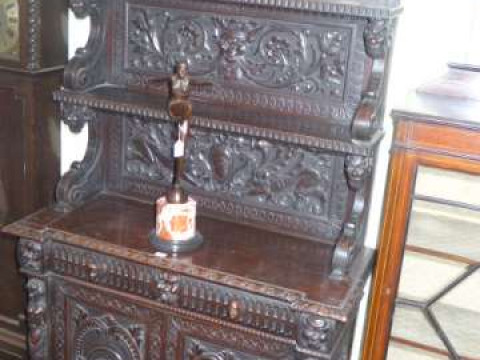 Victorian heavily carved oak two door cabinet having arched shelf back