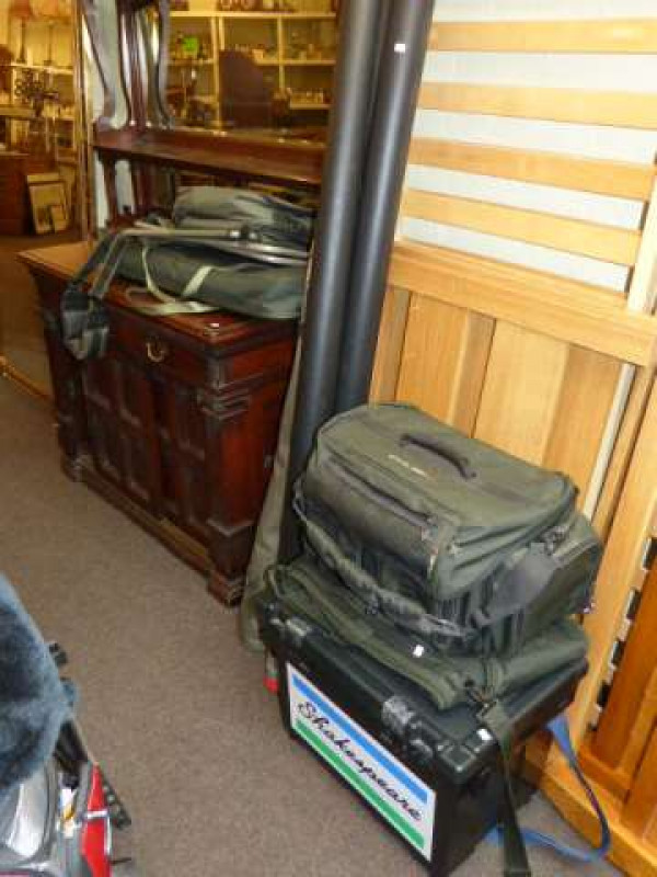 Collection of fishing equipment including rods, Shakespeare seat box, green holdall, folding seat, landing net, etc