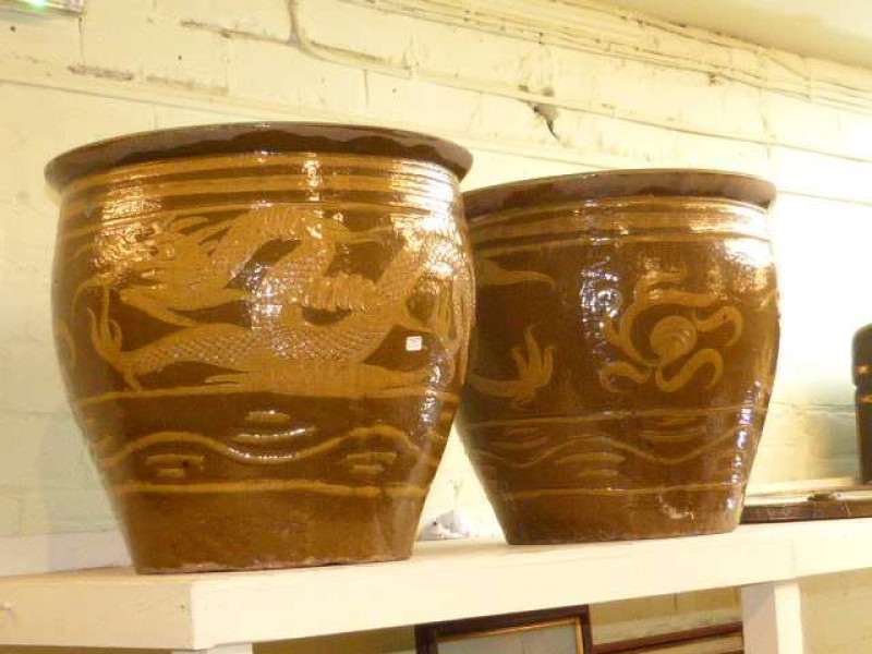 Pair of large Oriental design earthenware planters with dragon decoration and brass framed oval wall mirror