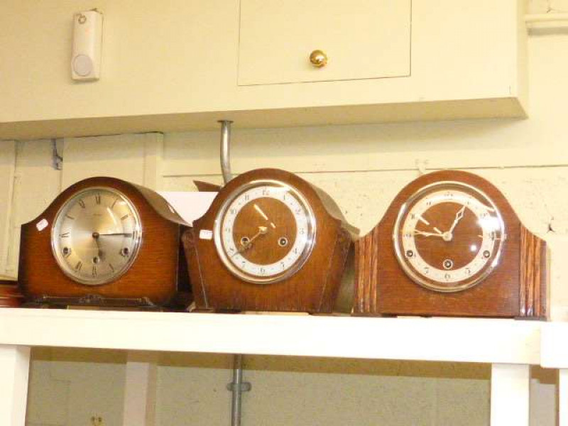 Three oak mantel clocks and modern barometer