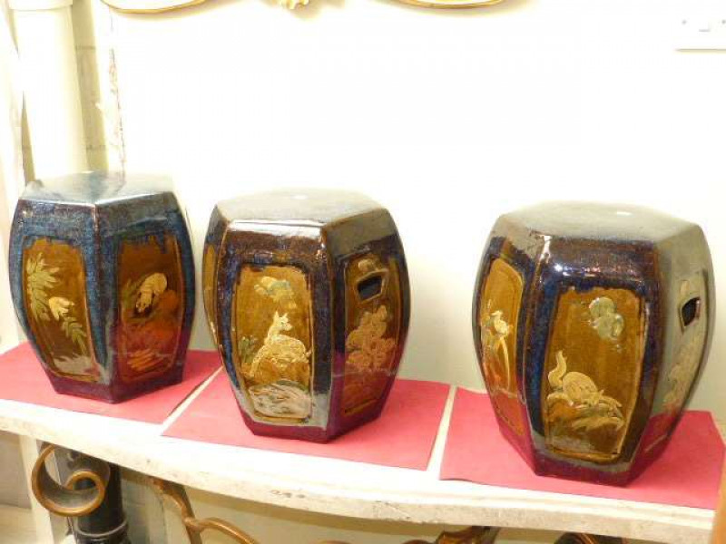 Three modern Chinese pottery hexagonal stools with floral and animal decorated panels