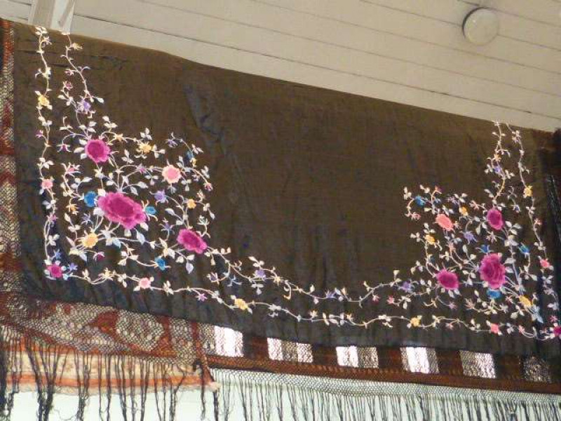 Silk and lace table cover with colourful floral design to corners and border